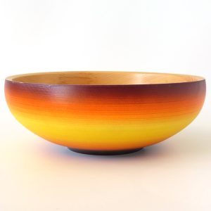 Purple, orange and yellow coloured pine bowl turned by Paul Hannaby creative woodturning